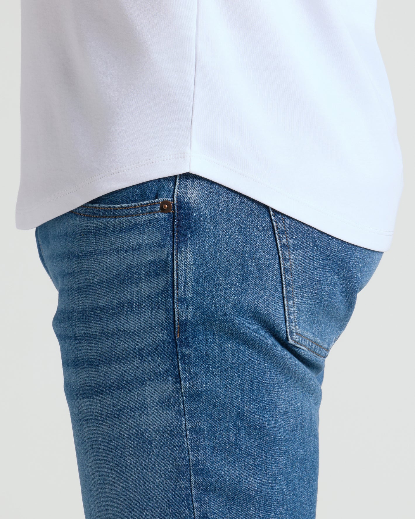 White Premium Pima Crew Curved Hem T-shirt tucked into blue jeans.