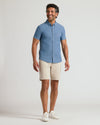 Man wearing Light Indigo Wash Short Sleeve Stretch Chambray Shirt, beige shorts.