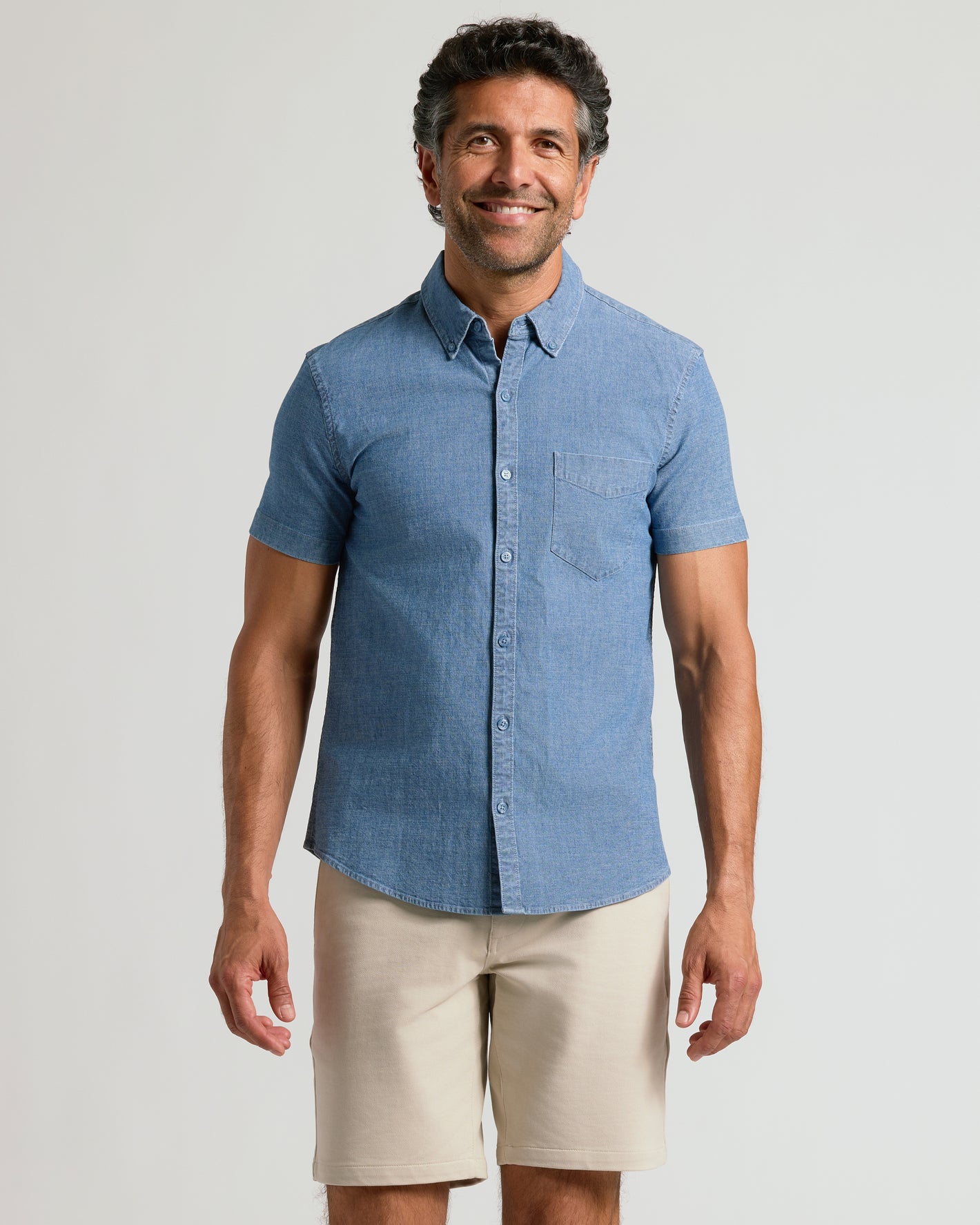 Man wearing Light Indigo Wash Short Sleeve Stretch Chambray Shirt smiling.