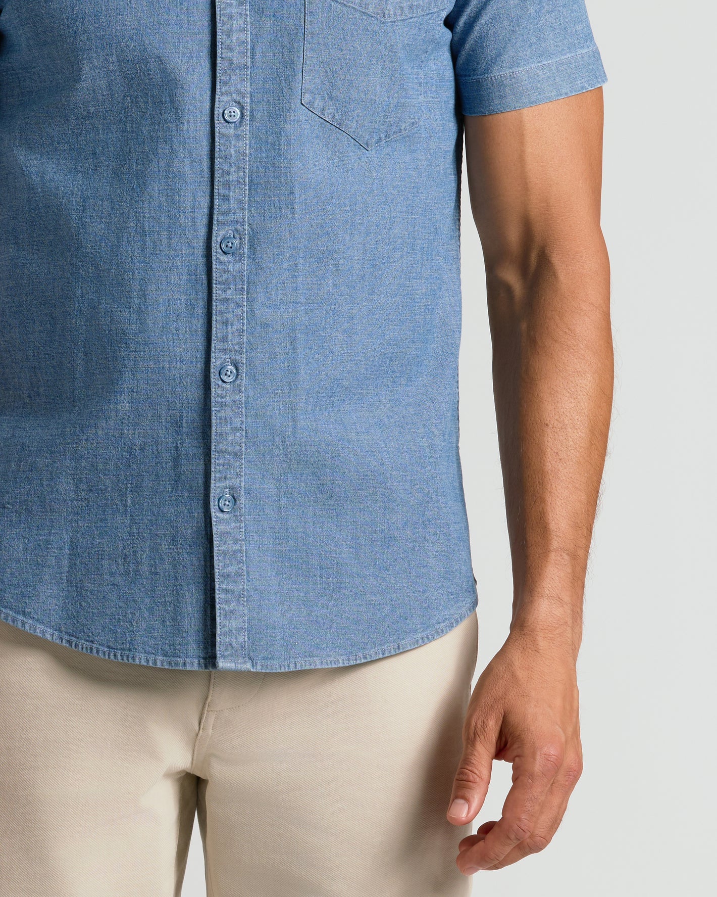 Light Indigo Wash Short Sleeve Stretch Chambray Shirt worn with beige pants.