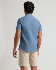 True ClassicBack view of man in Light Indigo Wash Short Sleeve Stretch Chambray Shirt.
