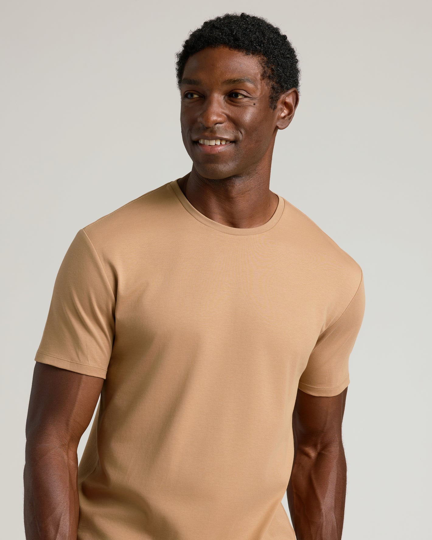 Man wearing Tahini Premium Pima Crew Neck, showcasing a relaxed fit.