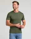Man wearing Pima Cotton Blend Crew 4-Pack T-shirt, smiling gently.
