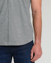 Heather Gray Short Sleeve Comfort Knit Shirt untucked over dark blue jeans.