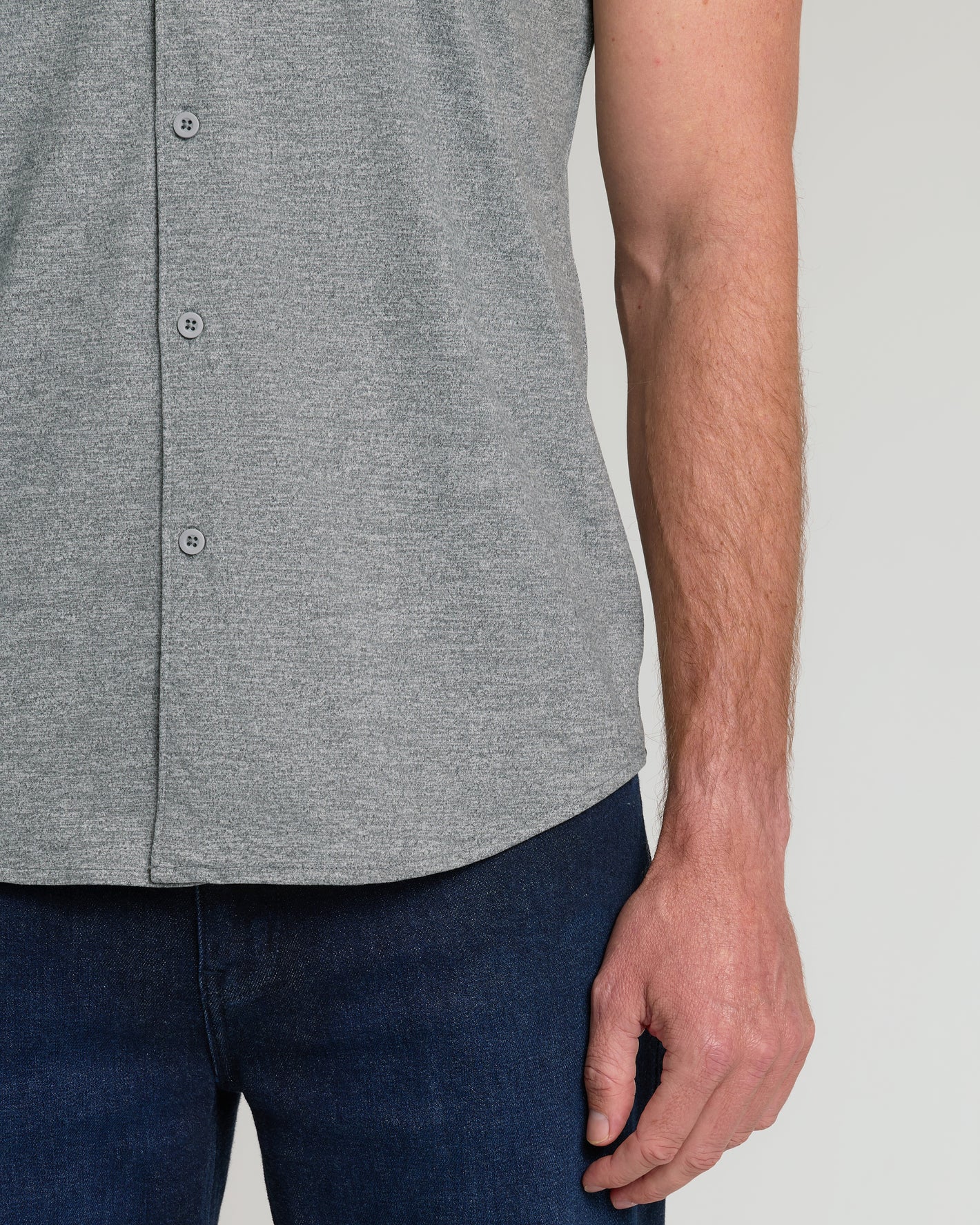Heather Gray Short Sleeve Comfort Knit Shirt untucked over dark blue jeans.
