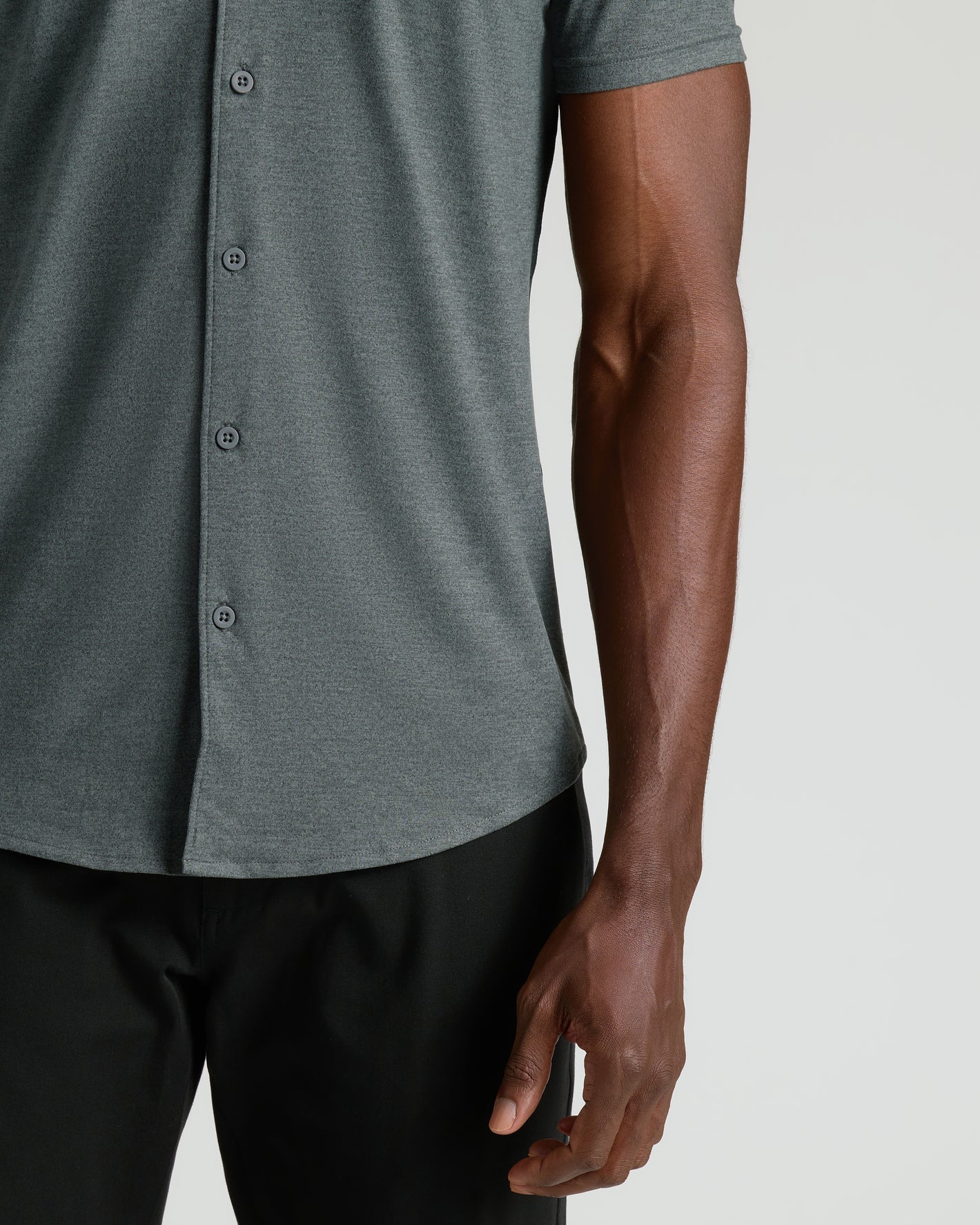 Charcoal Heather Gray Short Sleeve Comfort Knit Shirt worn with black trousers.