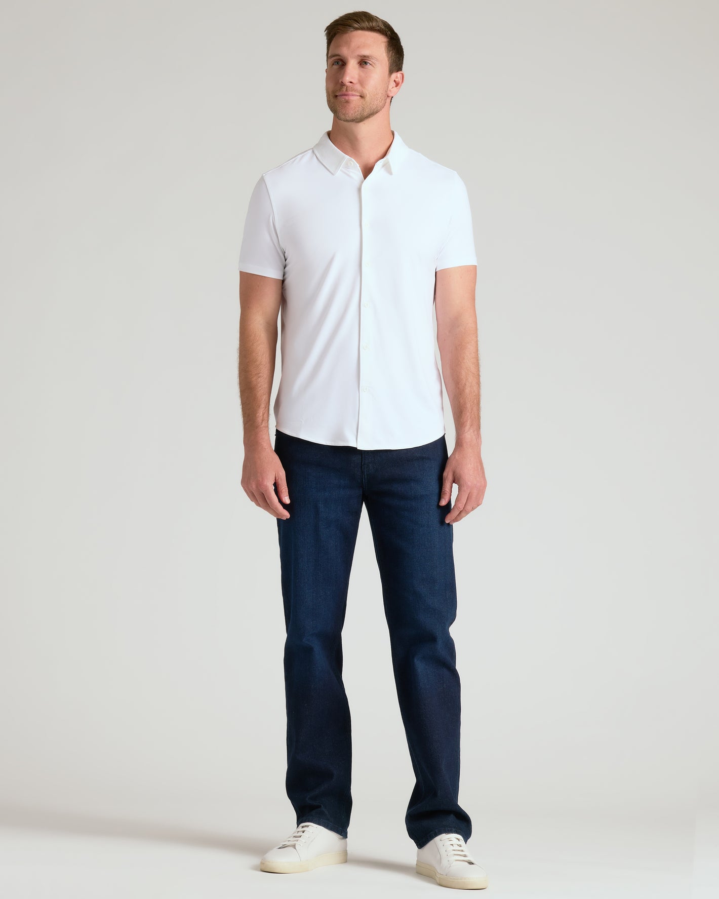 White Short Sleeve Comfort Knit Shirt on man, relaxed pose, casual style.