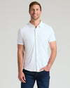 Man in White Short Sleeve Comfort Knit Shirt and dark jeans, smiling.