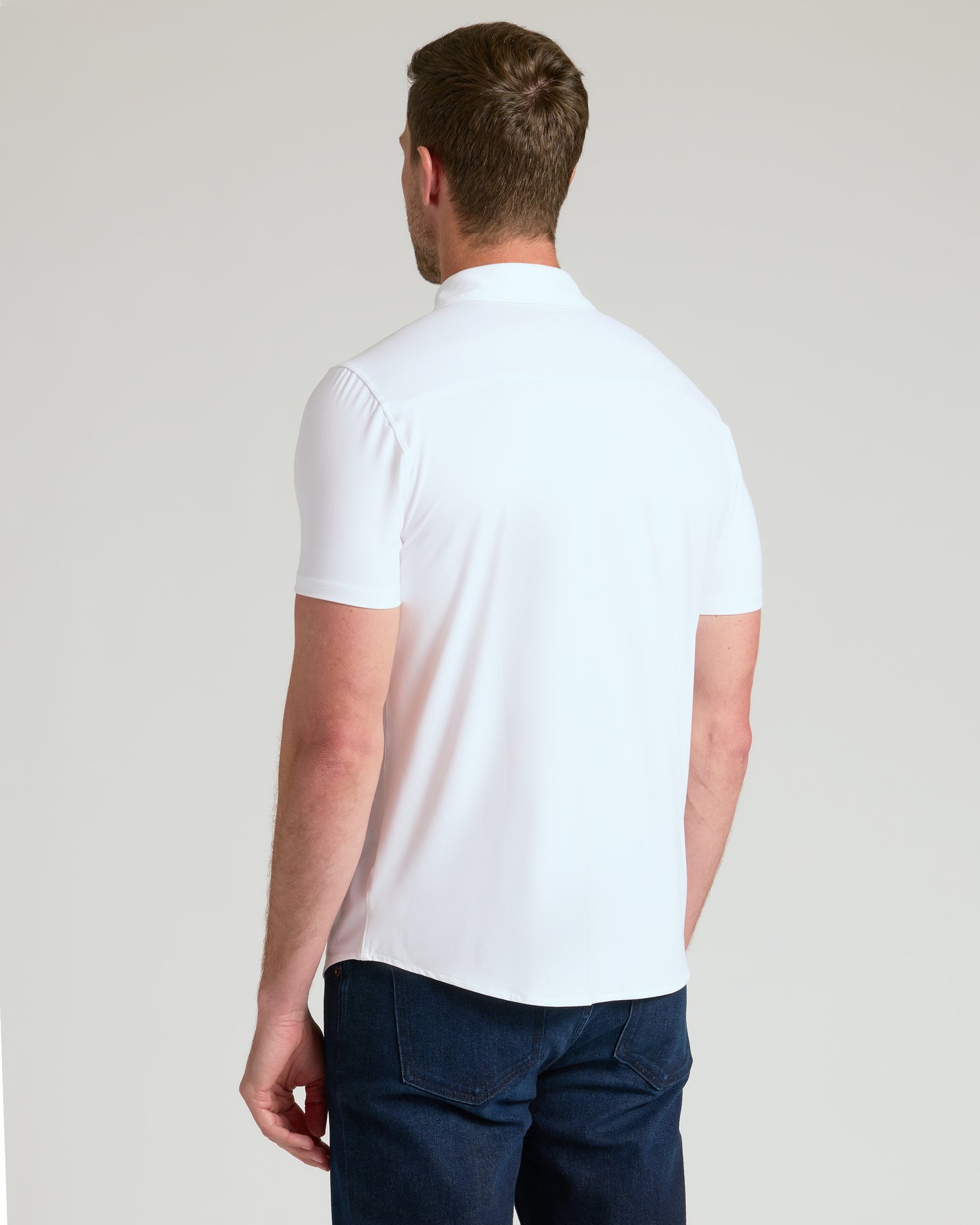 White Short Sleeve Comfort Knit Shirt on man, showcasing relaxed fit and style.