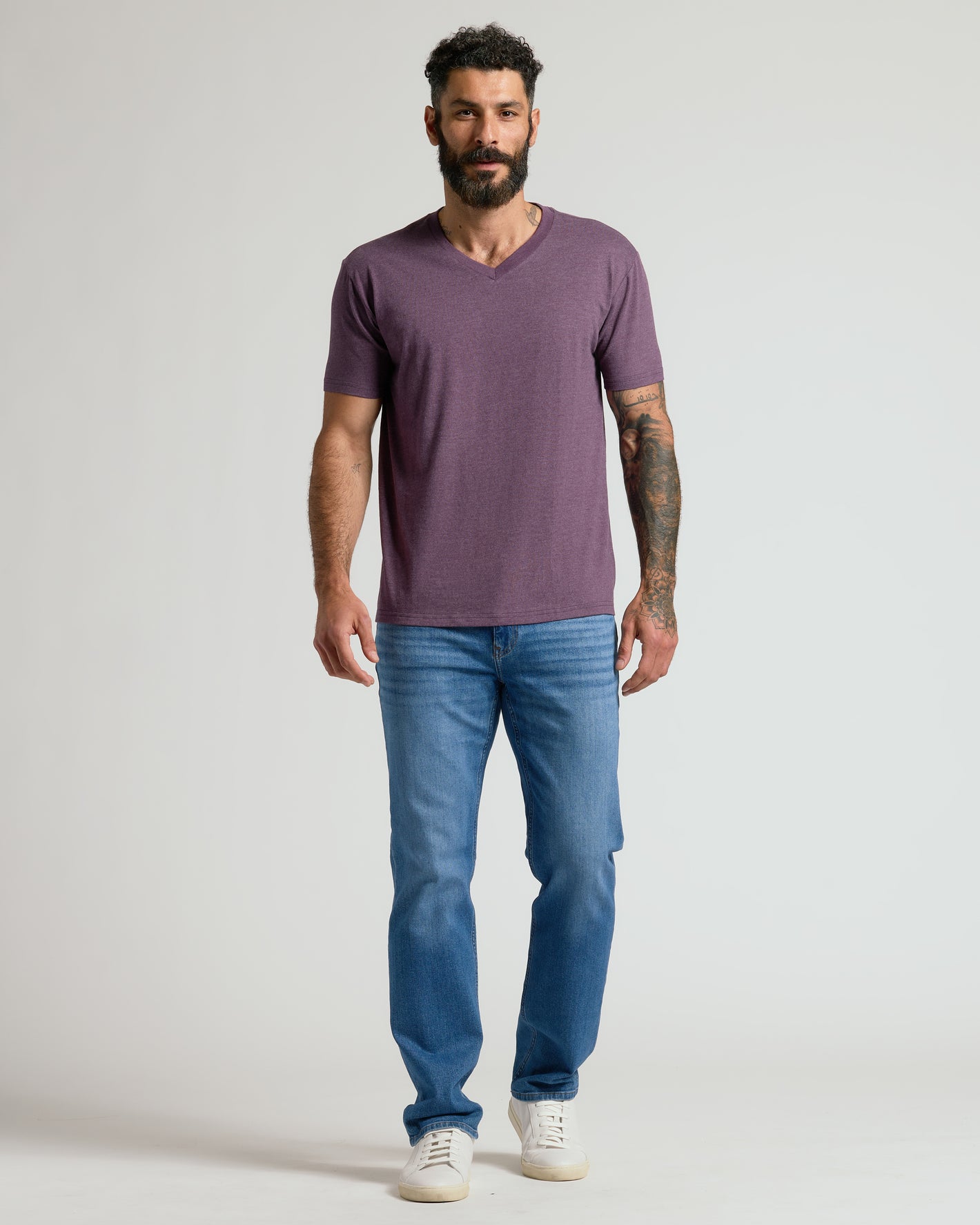 Man wearing Dark Heather Plum Classic V-Neck with jeans and sneakers.