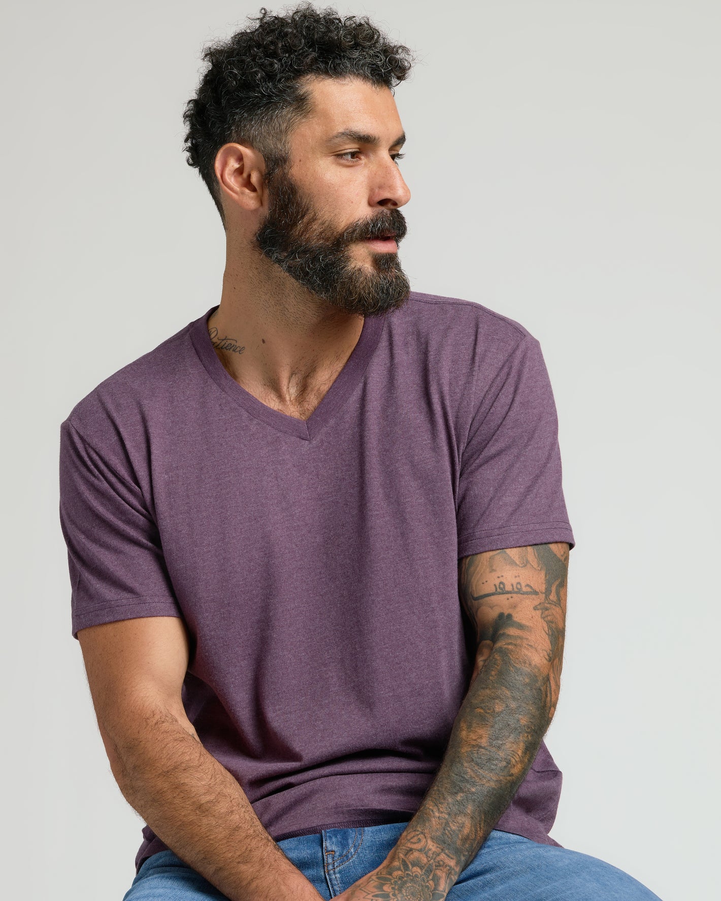 Man wearing Dark Heather Plum Classic V-Neck, showcasing its fit and style.