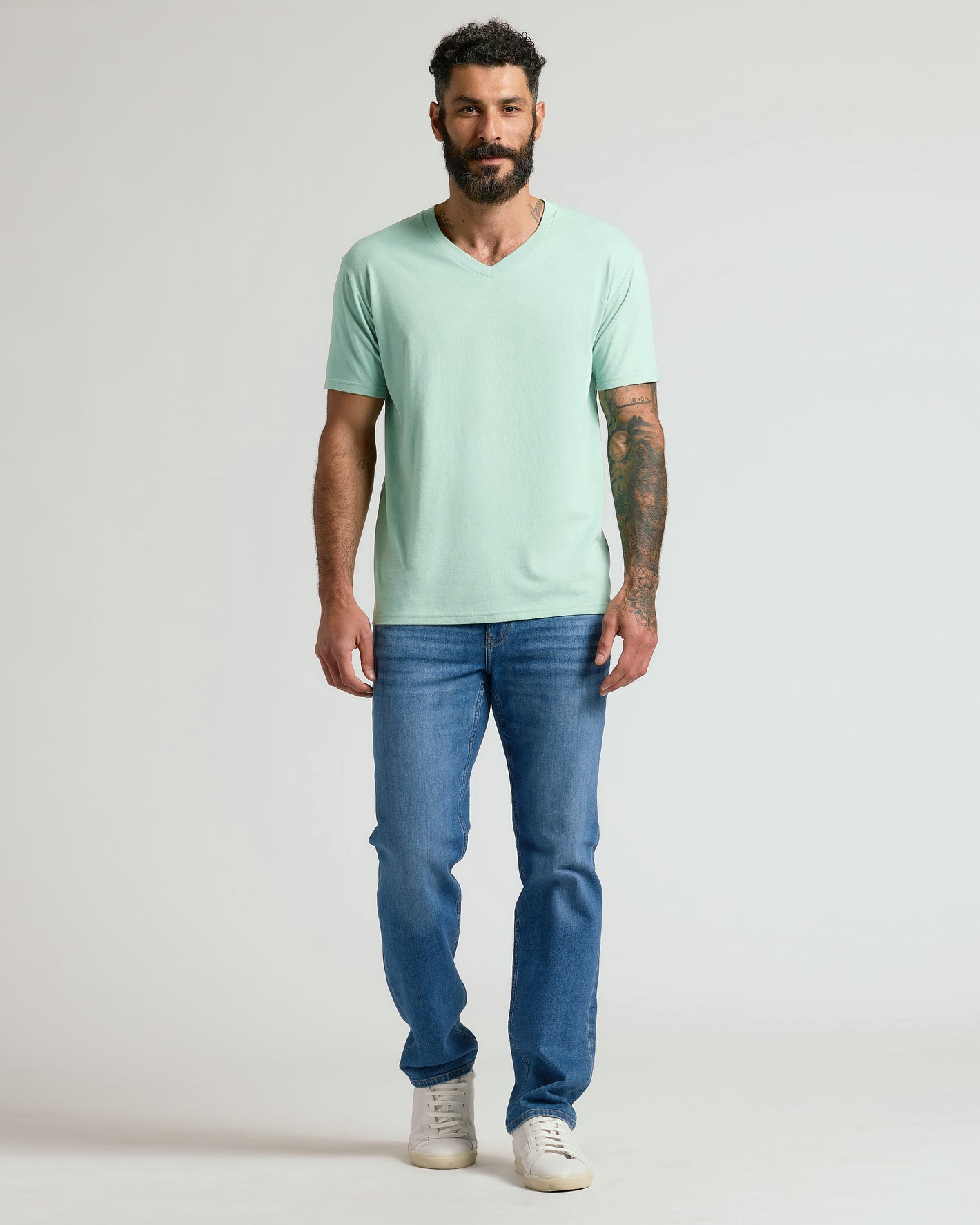 Heather Mist Classic V-Neck on male model with jeans and sneakers.