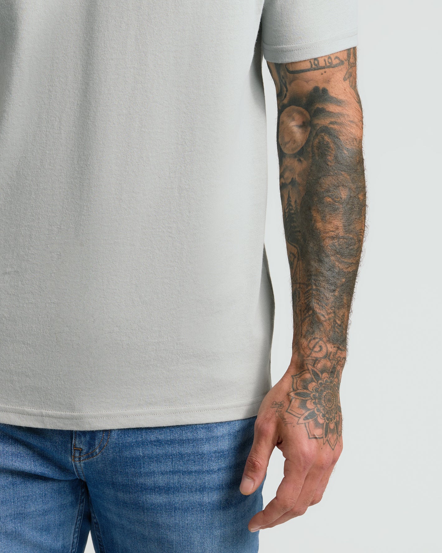 Steel Classic V-Neck worn with tattooed arm visible.