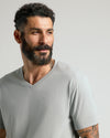 Steel Classic V-Neck worn by tattooed man with short curly hair.
