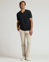 Black Premium Pima V-Neck on man with beige chinos and sneakers.