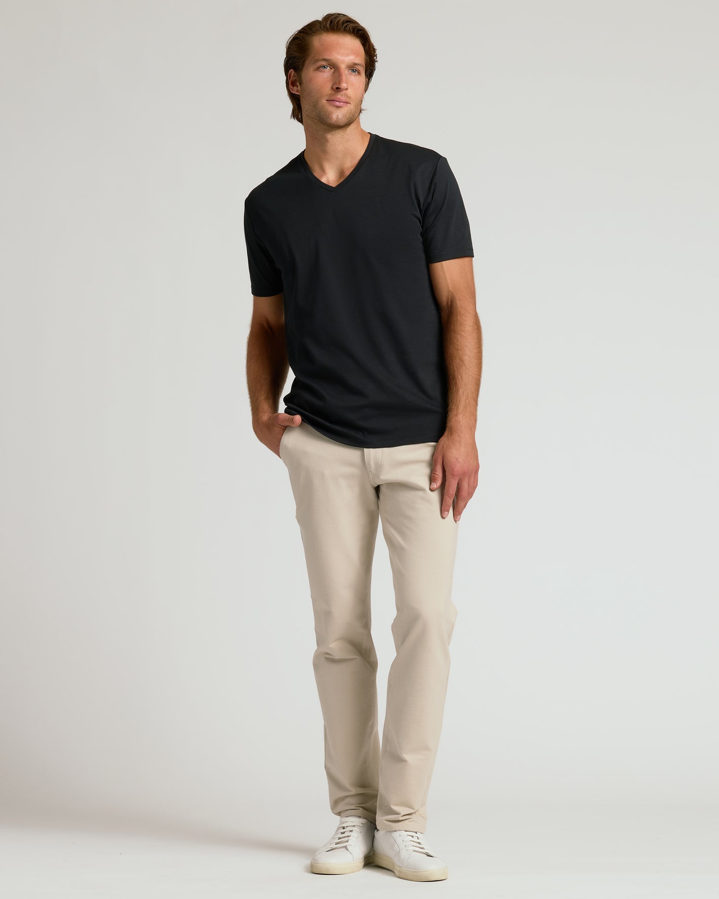 Black Premium Pima V-Neck on man with beige chinos and sneakers.