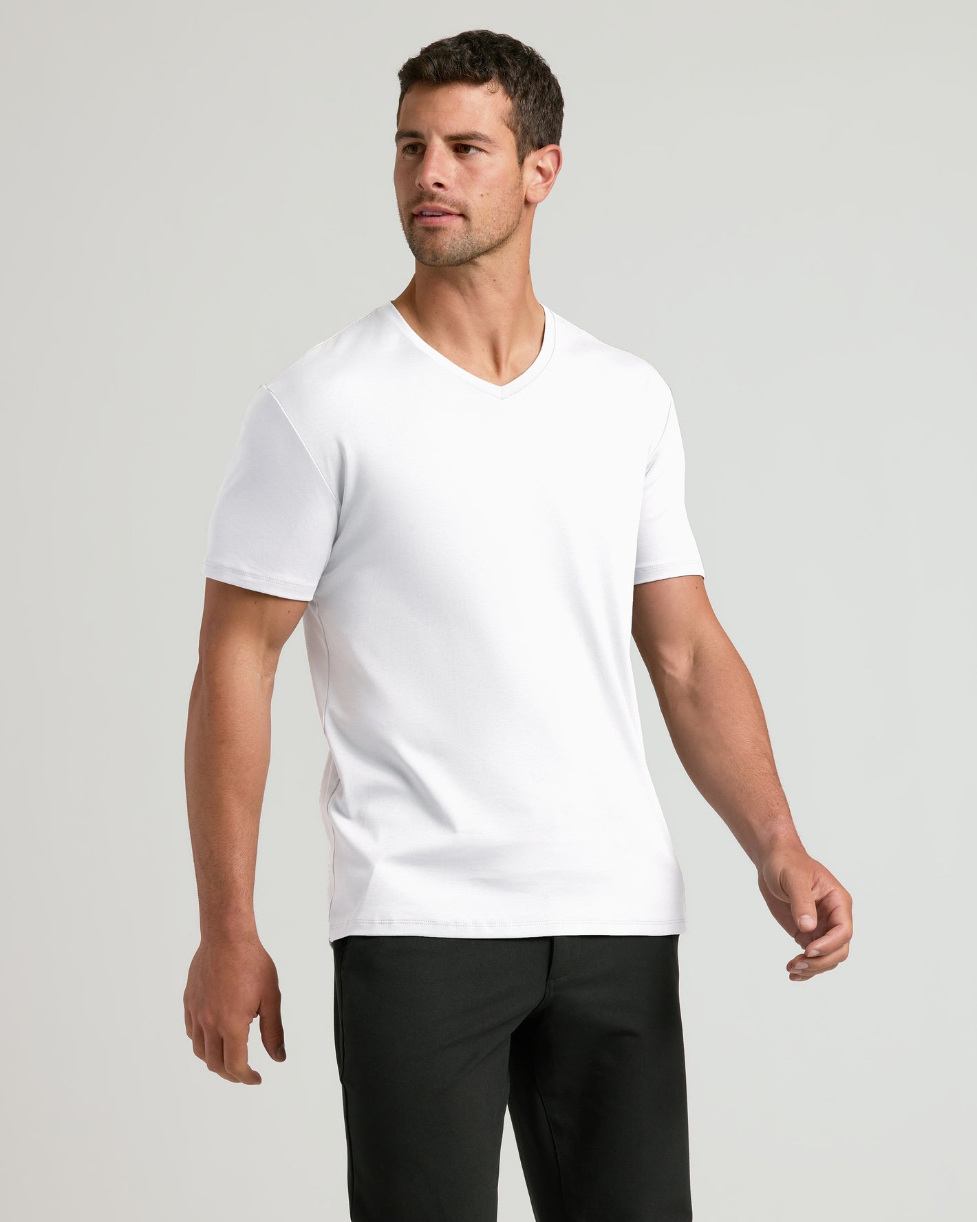 Man models White Premium Pima V-Neck 4-Pack, showcasing tailored fit.