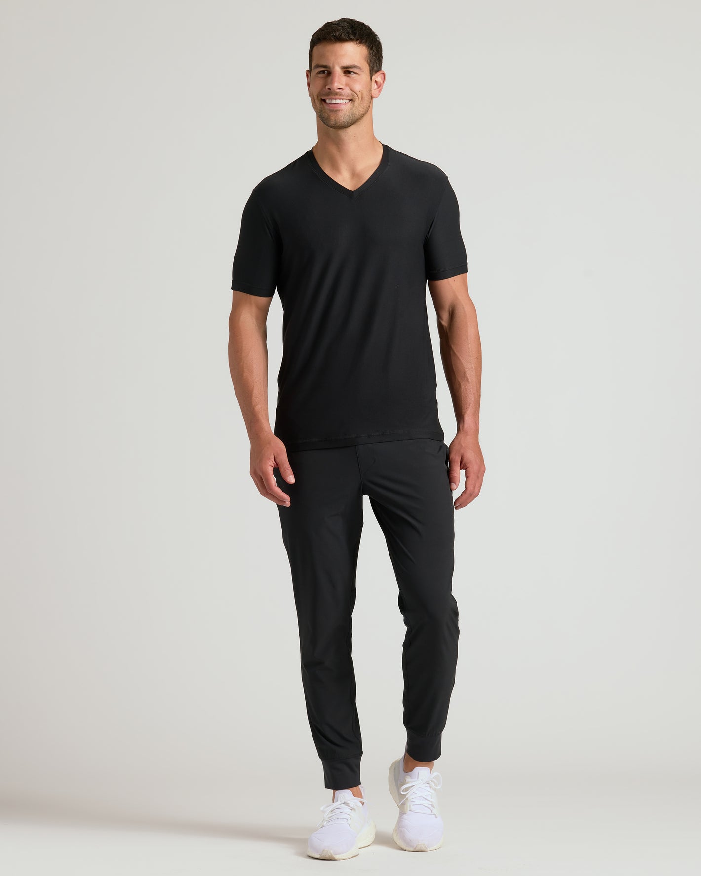 Black Active V-Neck on male model with joggers and sneakers.