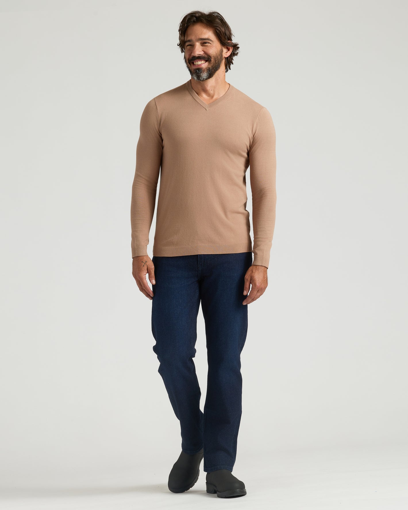 Man in Truffle & Blueberry Dressy V-Neck Sweater 2-Pack, walking and smiling.