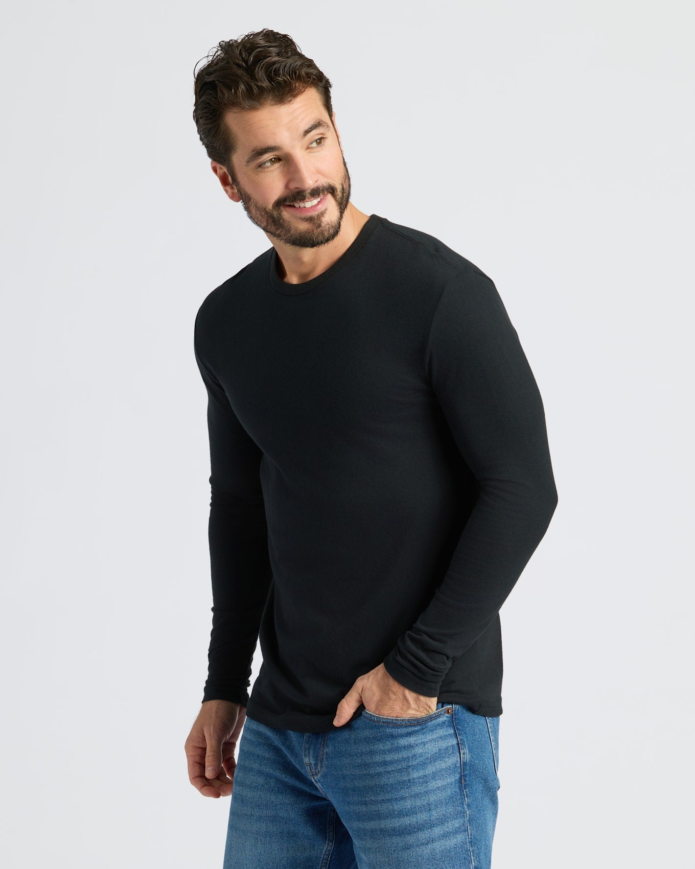 Man in Classic Long Sleeve Crew Neck, smiling, hand in pocket.