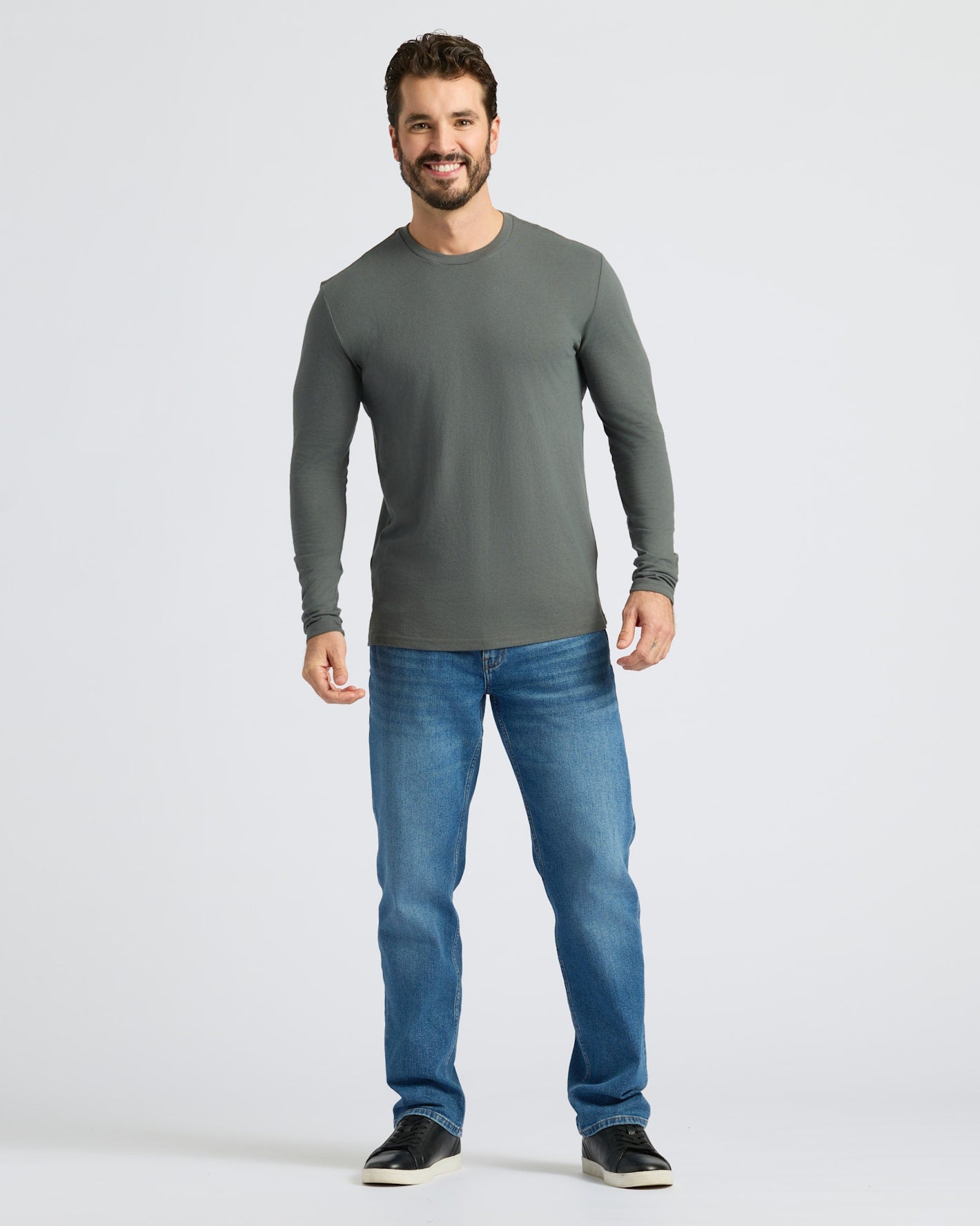 Man in Seasonal Classic Long Sleeve Henley, relaxed pose.