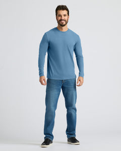 True ClassicA man modeling a light blue long-sleeve crewneck t-shirt and blue jeans against a light gray studio background.