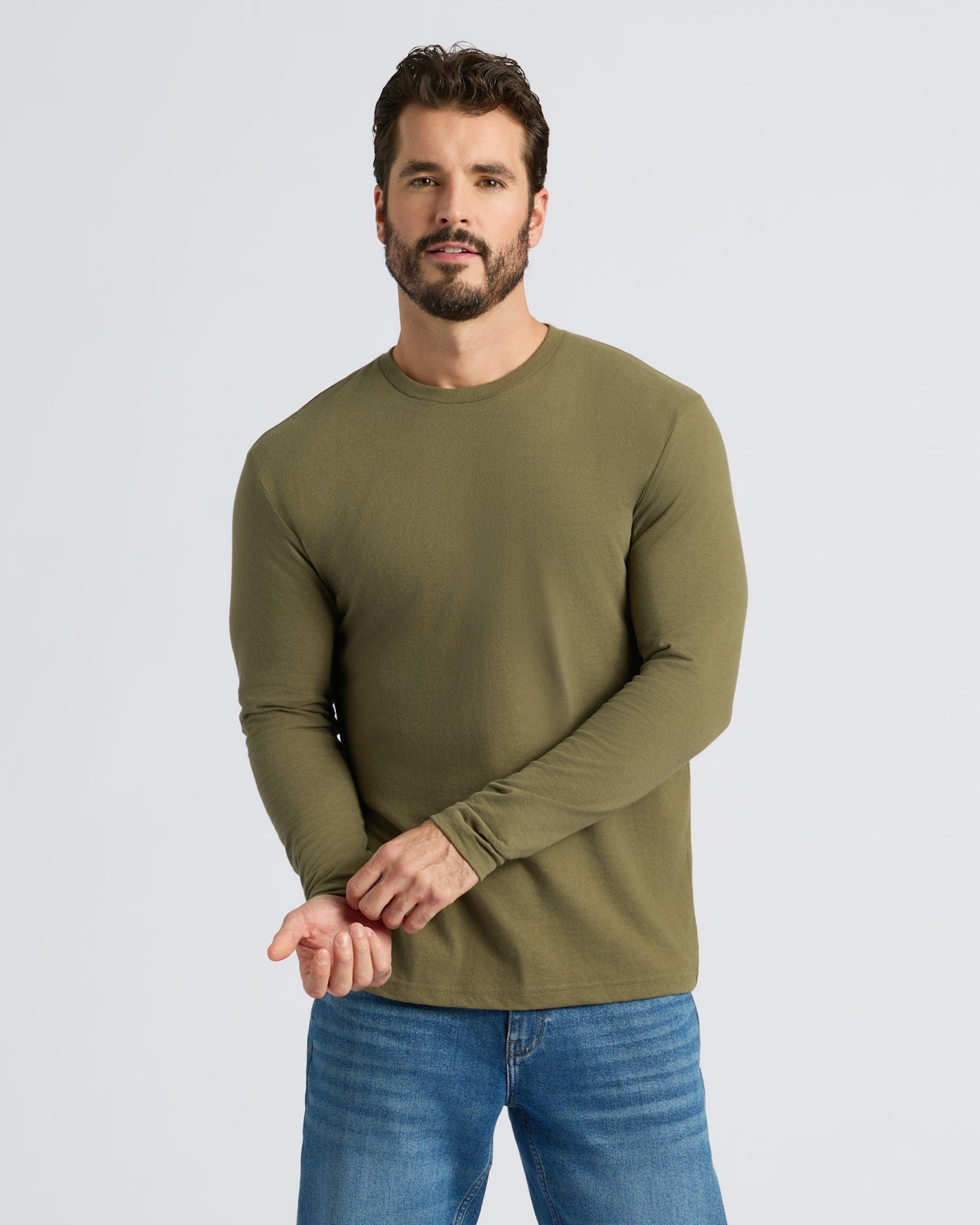 Man adjusts sleeve of Military Green Classic Long Sleeve Crew Neck.