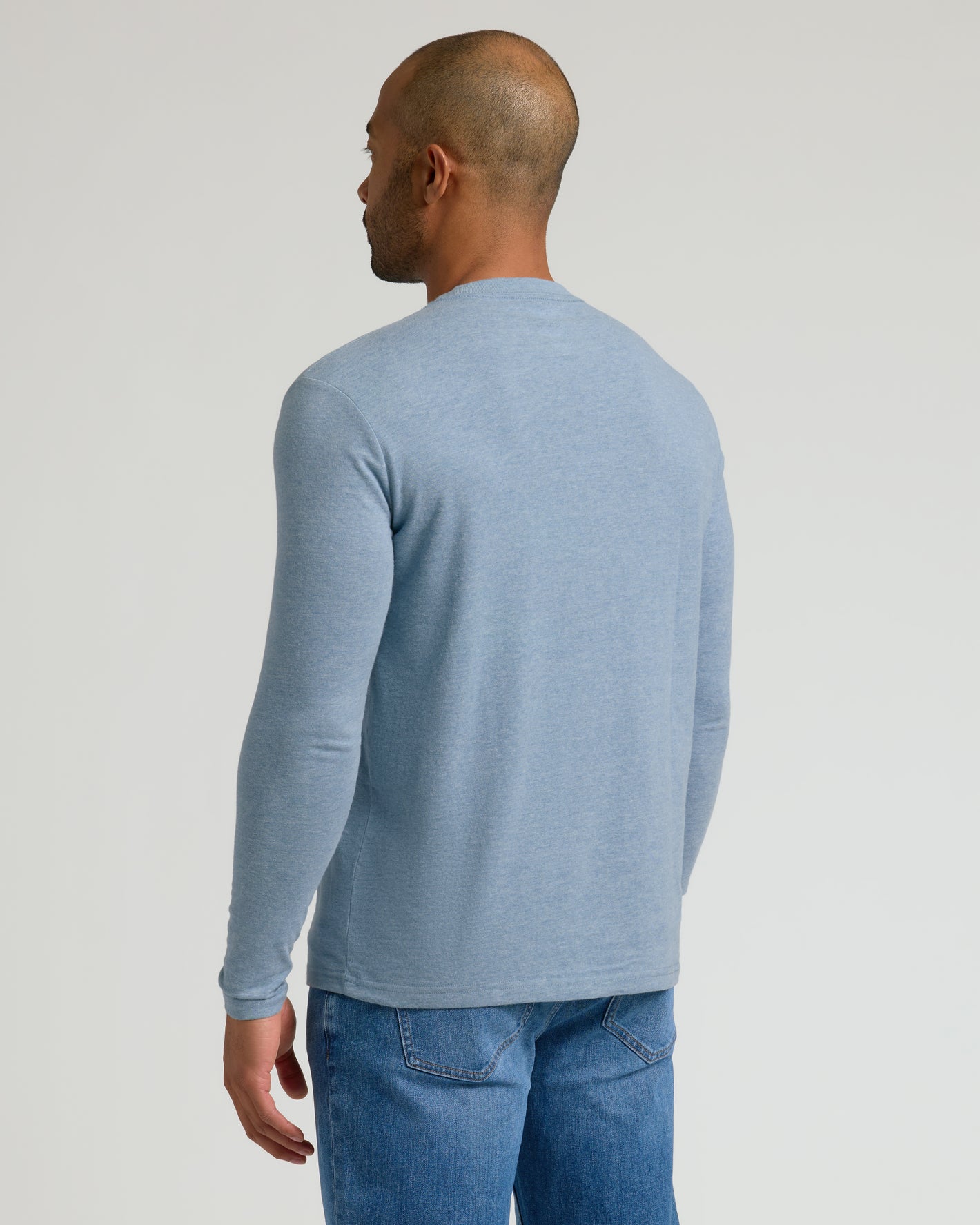 Rear view of a man in a fitted Heather Classic Long Sleeve.