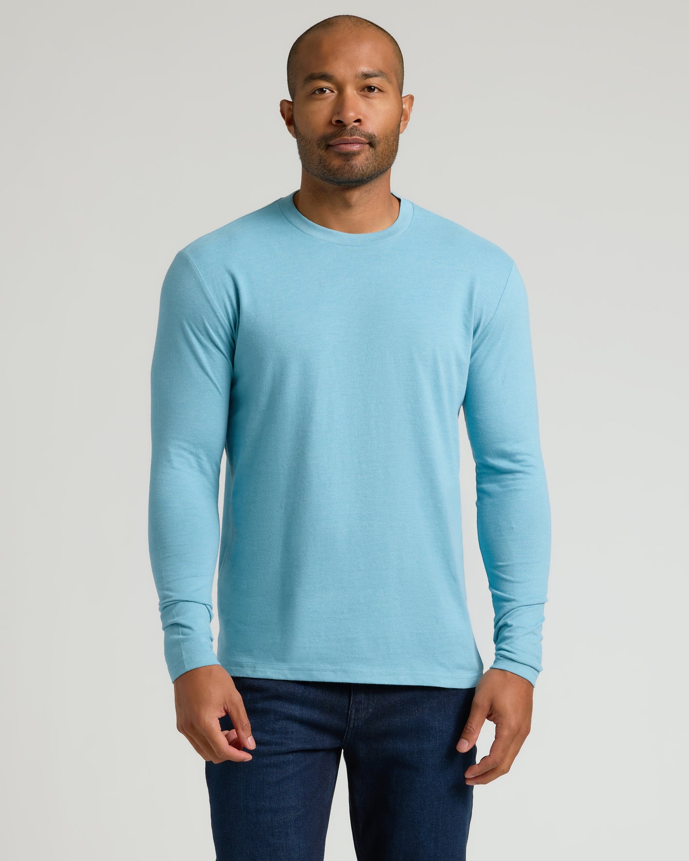 Heather Voyager Classic Long Sleeve Crew Neck on man, relaxed pose.