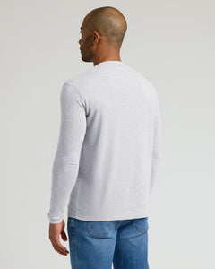 True ClassicA man shown from the back wearing a light gray long-sleeve crewneck shirt and blue jeans, photographed against a solid light gray studio background.