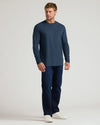 Man wearing Classic Long Sleeve Crew Neck 6-Pack, navy shirt and dark jeans.