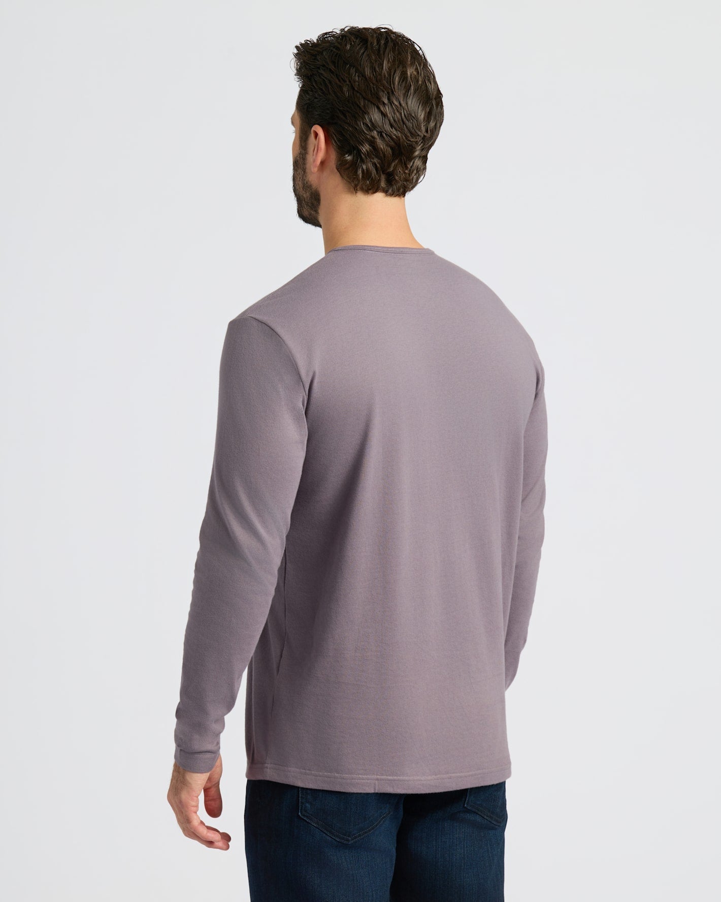 Man wearing Ashberry Classic Long Sleeve Henley and jeans, seen from behind.