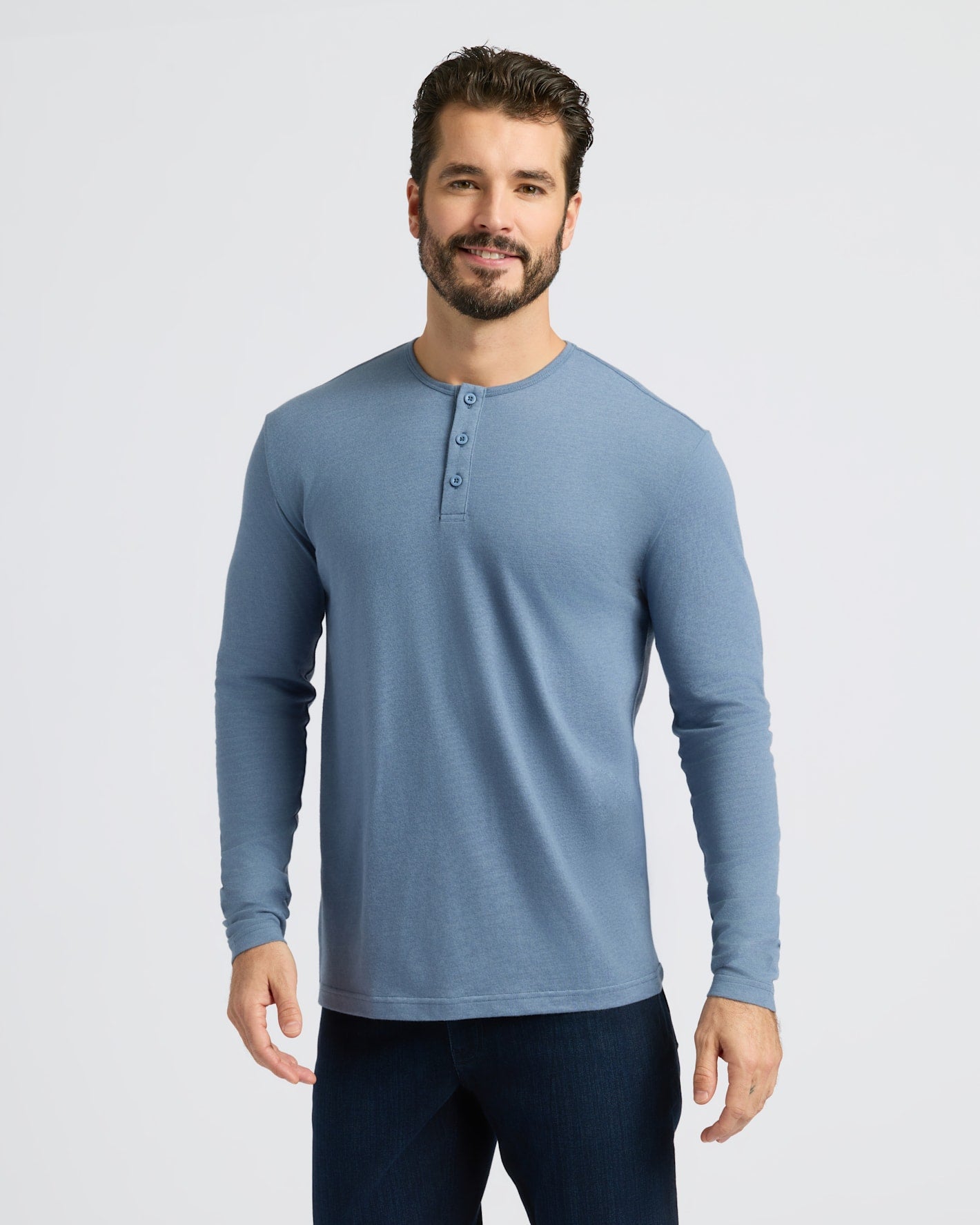 Man in Dark Heather Vintage Navy Classic Long Sleeve Henley smiling.