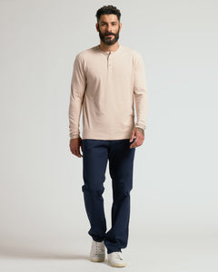True ClassicMan wearing a beige long-sleeve shirt and navy pants on a light gray background