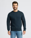 Man wearing Navy Fleece French Terry Pullover Crew Neck and blue jeans.