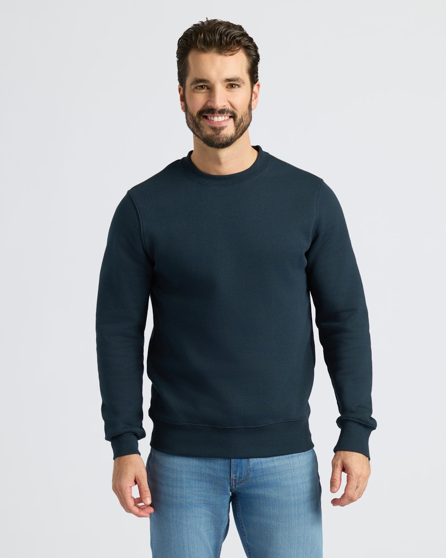 Man wearing Navy Fleece French Terry Pullover Crew Neck and blue jeans.