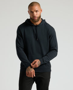 True ClassicModel wearing All Black Classic Waffle Hoodie, showing kangaroo pocket and drawcords.
