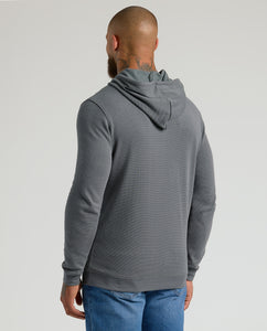 True ClassicMan in Carbon Waffle Hoodie and jeans, back view.