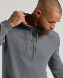 True ClassicMan wearing Carbon Waffle Hoodie, lifting hood slightly.