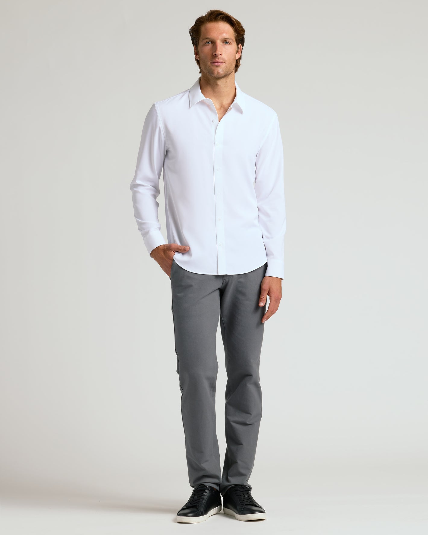 Man wearing All White Long Sleeve Performance Dress Shirt, showcasing relaxed slim fit.