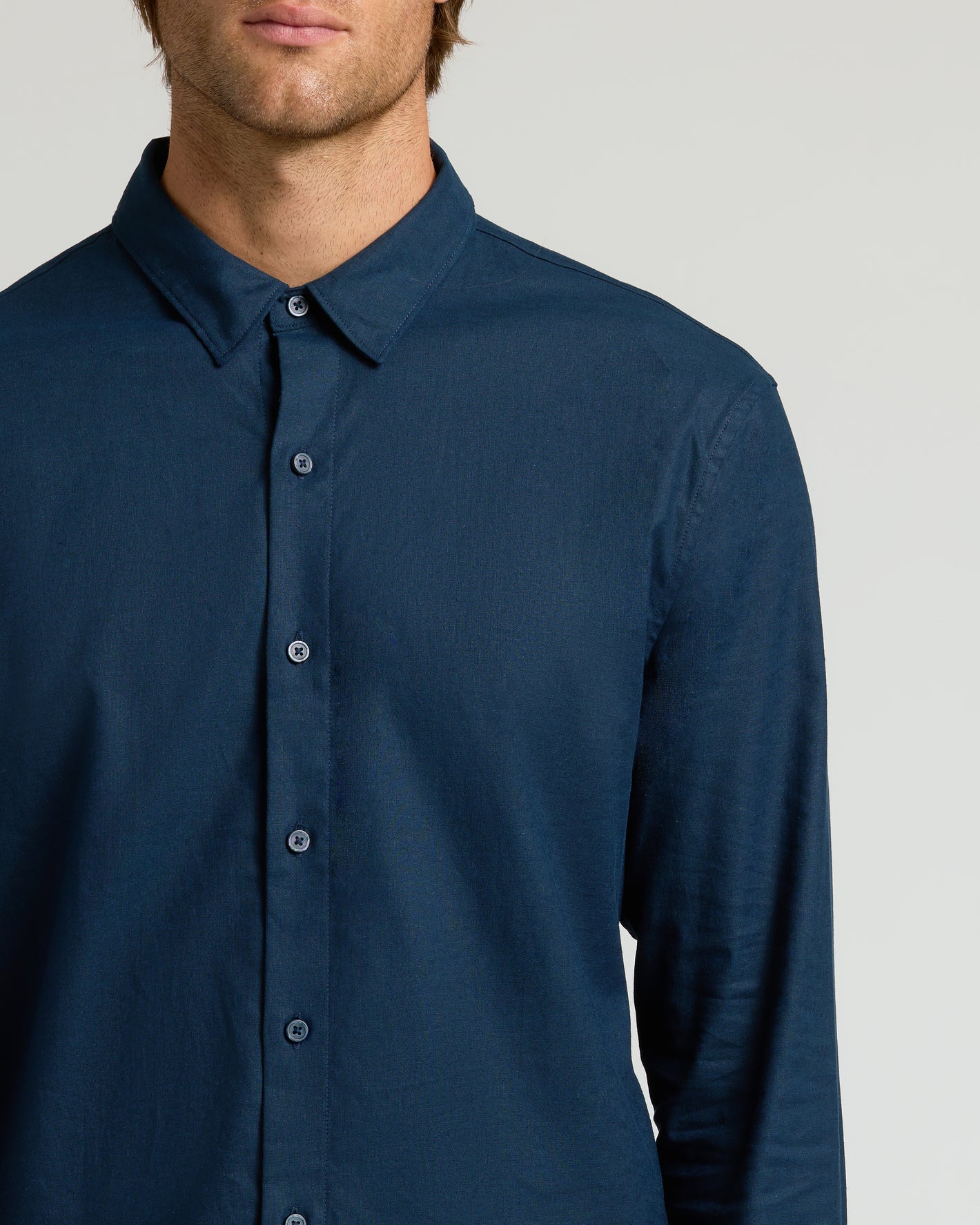 Navy Long Sleeve Linen Shirt on male torso, buttoned and collared.