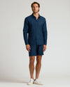 Model in Navy Long Sleeve Linen Shirt with matching shorts and sneakers.