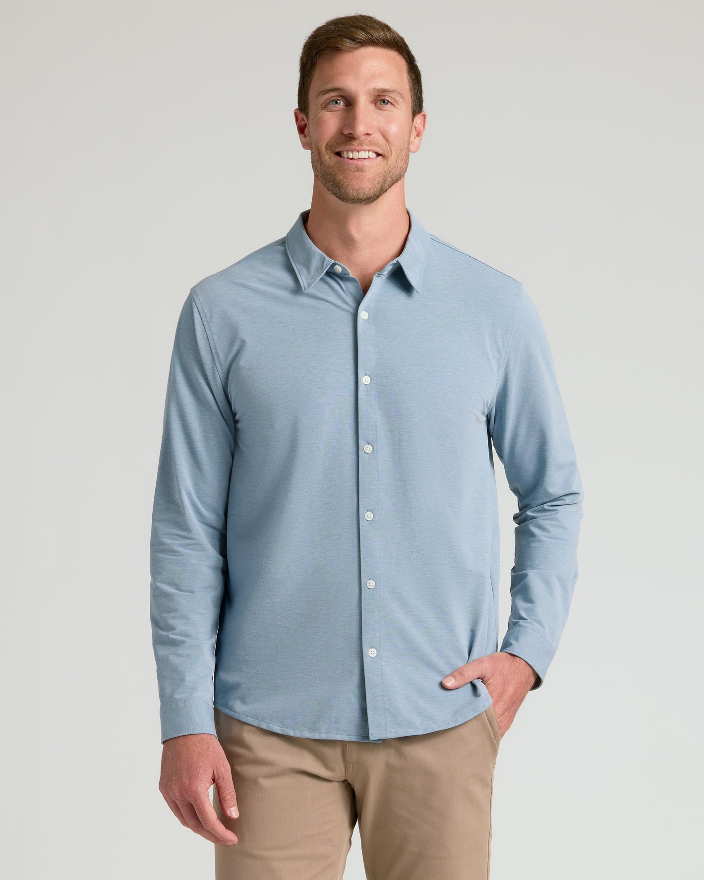 Man wearing Standard Long Sleeve Modern Knit Oxford, smiling, hand in pocket.