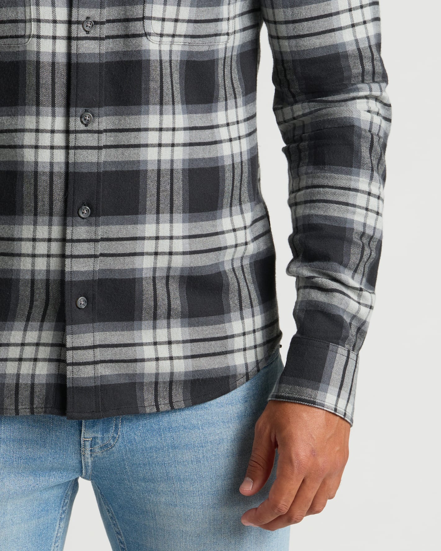Onyx Plaid Long Sleeve Flannel Shirt with light-wash jeans.