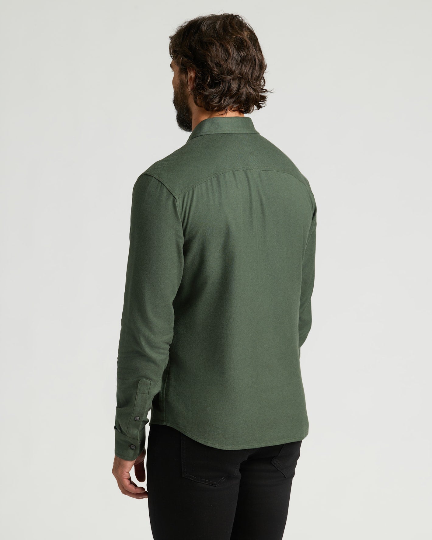 Man wearing Woodland Long Sleeve Flannel Shirt, seen from behind.