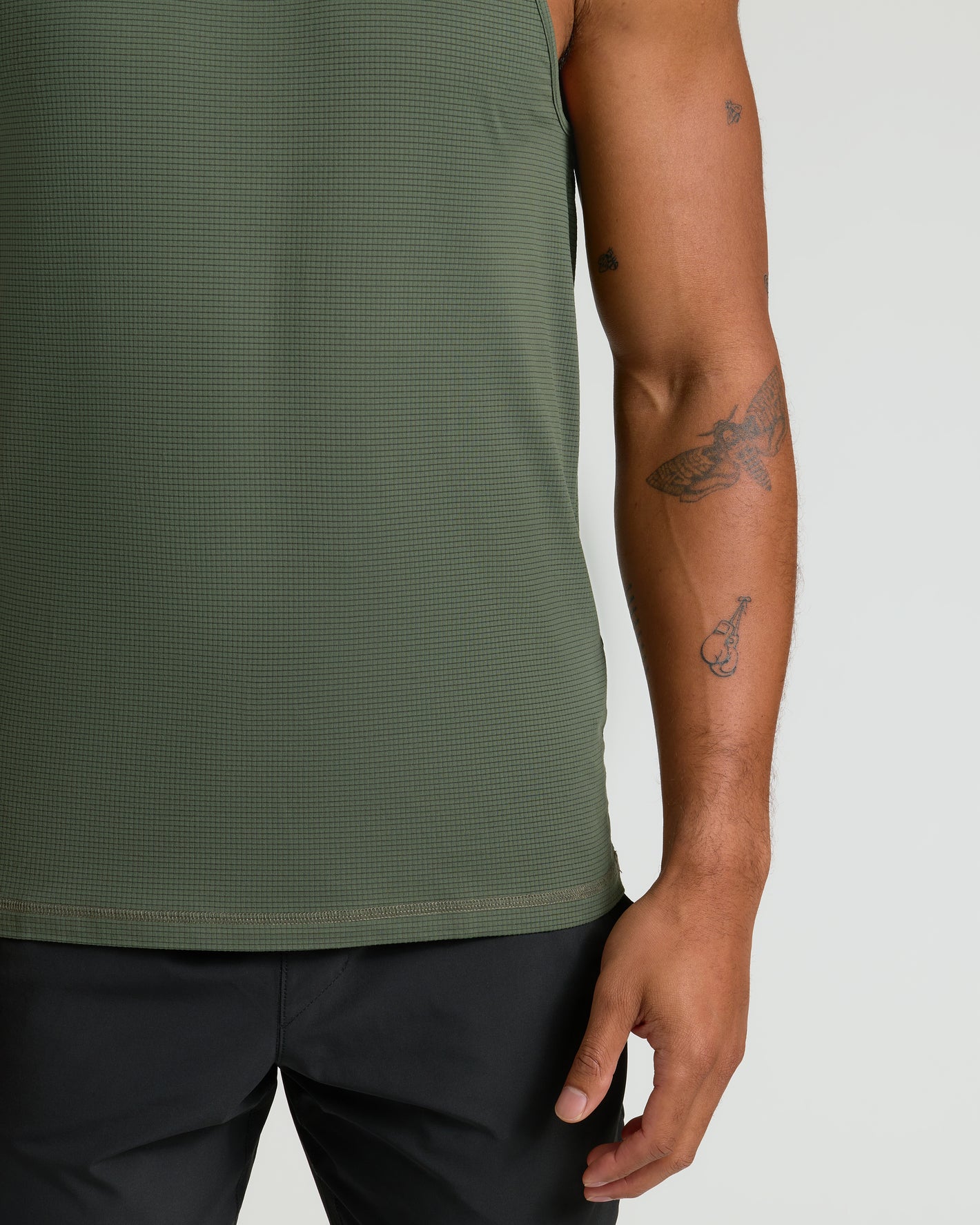 Kelp Sleeveless Active Mesh Tank on person with tattoos, showcasing fit.