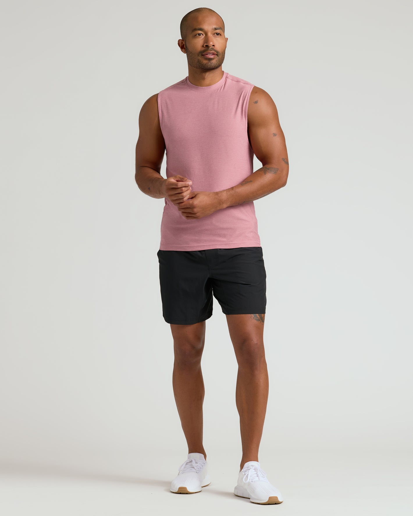 Quartz Rose Sleeveless Active Muscle Tee on model, paired with black shorts.
