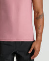 Quartz Rose Sleeveless Active Muscle Tee showcased on a tattooed forearm.