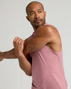 Quartz Rose Sleeveless Active Muscle Tee on athletic man stretching.