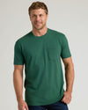 Man wearing Balsam Pocket Crew Tee, smiling softly.